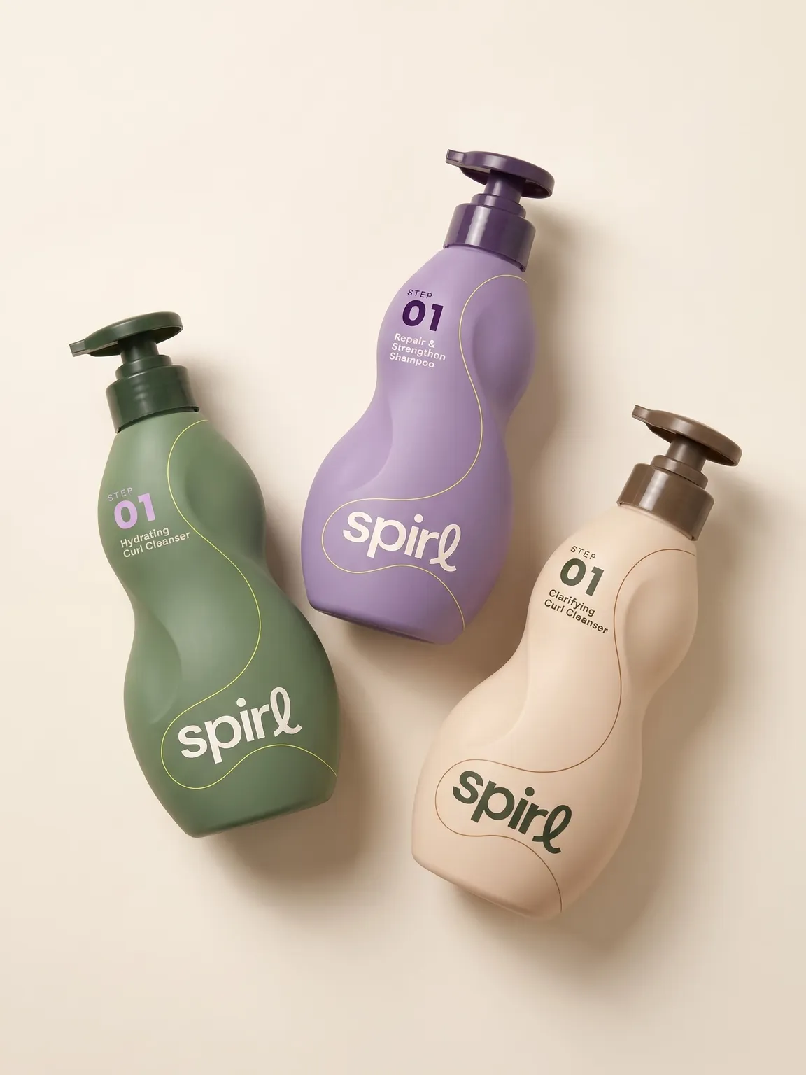 Step 01 cleanser range in green, lilac and cream, laid flat on a warm neutral background