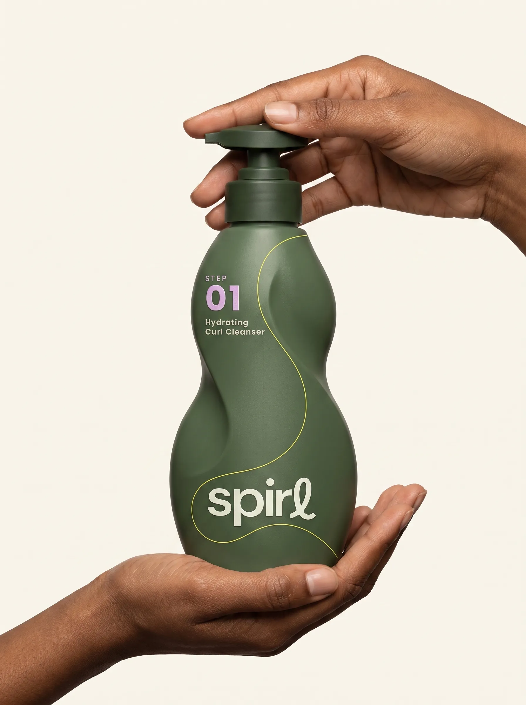 Hands pumping the green Step 01 Hydrating Curl Cleanser bottle