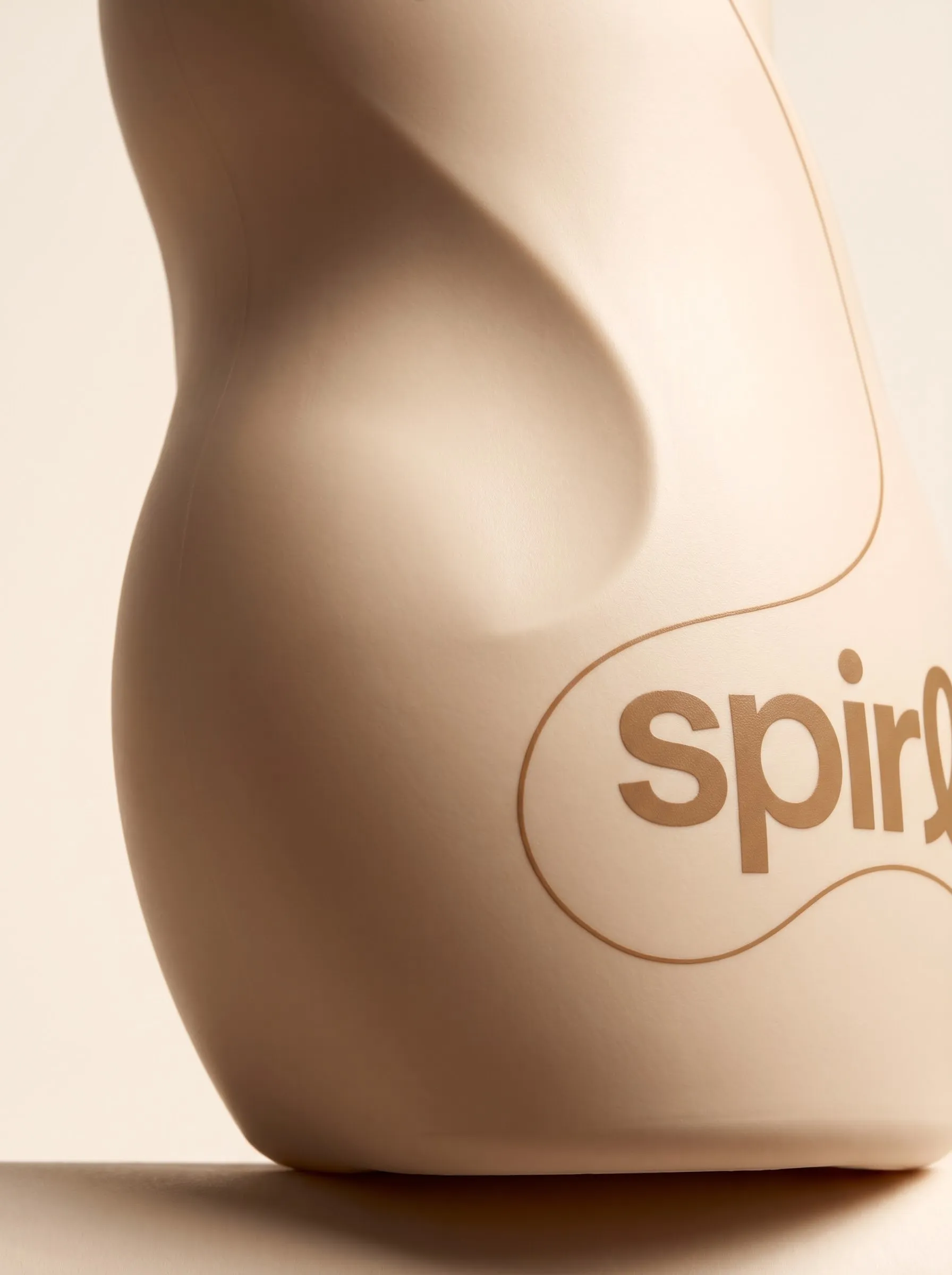 Debossed spirl wordmark curving around the shoulder of the cream jar